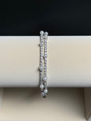 Pearl bracelet on a white jewelry display box with a black background