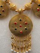 Detail of the tassel fringe on the centerpiece pendant showing teardrop drops and pearl-tipped ends