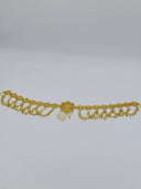 Full flat lay view of the gold-tone filigree rosette waist belt showing the full length, repeating medallion links, diamond charm swag drops, and central floral medallion with chain tassel