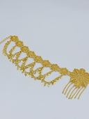 Side angle view of the full waist belt showing the extension chain closure, filigree rosette medallion links, and the large floral centerpiece with chain tassel at right