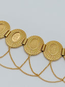 Close-up of three oval medallions showing the textured leaf-scale border, smooth oval center with rose engraving, bar hinge connections, and multi-strand swag chains