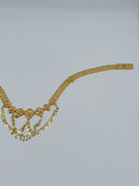 Angled view showing the rectangular bar clasp closure end of the clover-link mesh chain body and one heart fan medallion with coin disc drops