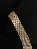 Gold bracelet with a black background