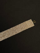 Silver beaded bracelet on a black background