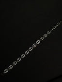 Silver chain bracelet on a black background