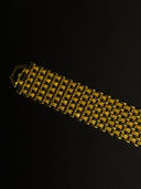 Gold bracelet on a black background