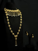 Full set view of a gold-tone diamond tile choker and long necklace with chain tassels and pearl-like beads, displayed on a black bust alongside matching drop earrings
