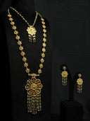 Gold-tone 3-piece jewelry set on black bust — long filigree flower-link necklace with large openwork pendant and bead tassels, shorter necklace, and matching drop earrings