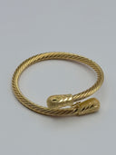 Side profile of gold-tone twisted rope cuff bangle with dual bullet end caps, open-cuff style