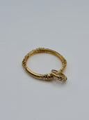 Full view of gold-tone wire-wrap open-cuff bangle with stacked granulated disc terminals and tapered bullet tips on white background