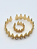 Close-up detail of the crown arch bangle showing granulated filigree texture, pearl accents, and gold ball finials on each peak