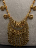 Close-up of the Hilal crescent moon filigree pendant showing layered open-lace scrollwork panels, beaded borders, and cascading tassel fringe with teardrop drops