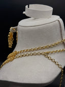 Back view of the Zahra necklace on a white display roll showing the gold-tone rolo-link chain construction