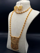 Gold-tone Sultana bridal jewelry set on a cream bust display, showing a long filigree sphere bead necklace with fan-shaped arabesque pendant and matching fan drop earrings