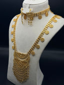 Gold-tone Majd parure on a cream bust showing a wide coin-disc choker with medallion drops, a long crescent filigree necklace with cascading fringe, and matching stud earrings