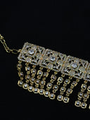 Close-up detail of the choker showing the square pavé panels with round and marquise-cut clear stones and the cascading cushion-cut stone tassel drops