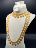 Close-up of gold-tone coin medallion drop earrings with beaded border and sunburst wheel motif, shown alongside the choker necklace chain