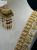Close-up of the drop earring alongside the coin charm chain — arch-top earring with rope border, red stone flower center, and coin disc and torpedo tassel drops