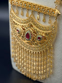Three-quarter view of the Khaleeji filigree crescent bib necklace and earrings set on a display stand showing the full silhouette, coin charm chain, and tassel fringe detail