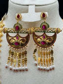 Full view of a Rajwadi-style 3-piece jewelry set on a cream bust, showing a long multi-strand gold coin chain necklace with a crescent pendant and matching chandelier earrings with pearl tassel drops