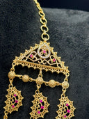 Overhead close-up of the bracelet showing the structured filigree panel centerpiece with pink stone floral motif and granulated bead border links