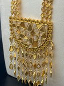 Detail of the lower half-moon pendant section showing the dense geometric charm fringe with alternating pave stone and plain gold-tone kite and diamond-shaped drops in multiple lengths