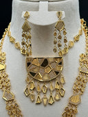 Close-up of the geometric mosaic necklace and earring set on a white bust, showing the half-moon pendant with alternating pave stone and ridged gold-tone mosaic panels and cascading mixed-shape charm fringe