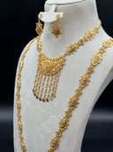 Three-quarter view of the full set on a white bust showing both necklaces layered together, the engraved diamond-station plaque chains, the crescent pendants, and the matching earrings against a dark background