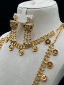 Three-quarter view of the full set on a white bust showing both coin chain necklaces layered together, the large half-moon pendant, and the chandelier earrings with tassel drops