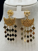 Close-up of the matching chandelier earrings on a white bust showing the round engraved floral stud tops, open lattice mesh crescent bodies with granulated borders, and multi-strand clover-and-diamond tassel fringe drops
