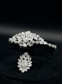 Detail of the zirconia bangle with floral oval halo centerpiece and leaf cluster sides, displayed alongside the matching ring