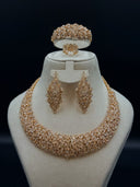 Full view of the 4-piece gold-tone marquise leaf cluster zirconia set on a white bust, showing the collar necklace, chandelier earrings, cuff bangle, and ring