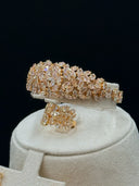 Close-up of the wide cuff bangle and leaf cluster ring showing dense champagne-toned marquise-cut stone paving in a cascading leaf arrangement
