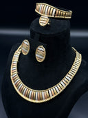 Angled view of the complete tri-tone ribbed jewelry set on a black velvet bust showing necklace, bracelet, earrings, and ring together