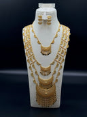 Close-up of the graduated crescent bib necklace showing two hilal tiers with diamond-cut lattice surface and full fringe of coin and teardrop drops