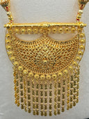 Flat lay close-up of the hilal pendant showing the full arabesque lattice surface, rosette border detail, and complete stacked coin drop fringe arrangement