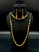 Full 3-piece jewelry set on a black velvet bust — long opera necklace and shorter collar necklace with twisted bead cluster diamond stations, and matching drop earrings