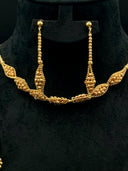 Front view of the collar necklace and drop earrings on a black velvet bust showing the diamond station construction and the tapered bead cluster drop earring detail