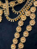 Flat lay close-up of the 3-strand daisy link opera necklace and coin drop collar necklace showing the continuous filigree daisy flower link construction and curb chain with coin discs