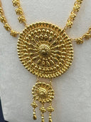 Close-up of the large circular sunburst centerpiece pendant with tiered beaded border and cascading teardrop drops