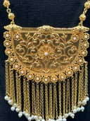 Front detail of the half-moon pendant highlighting the flower rosette border and central floral filigree motif