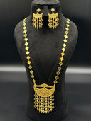 Full view of the 3-piece clover chain filigree moon tassel set on a black bust, showing the long necklace and chandelier earrings