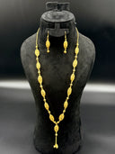 Full view of the 3-piece filigree oval lattice necklace and earring set displayed on a black bust