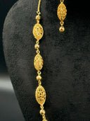 Side detail of the necklace showing repeating open-lattice oval beads and faceted round bead spacers
