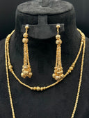 Detail view of the pair of drop earrings showing the stacked graduated ball beads with rope-cut texture