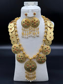 Full view of the engraved coin disc necklace and chandelier earring set displayed on a white bust against a dark background